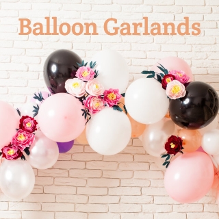 Pretty Balloon Garland with flowers, brick wall behind
