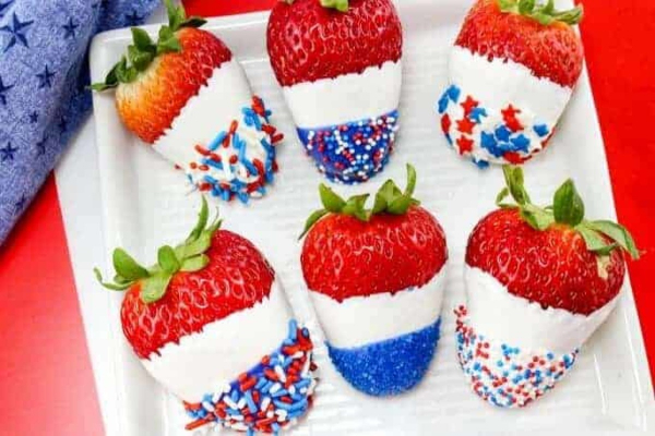 Strawberries covered in white chocolate with red white and blue sprinkles