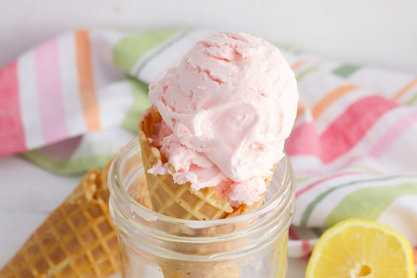 pink lemonade ice cream in a waffle cone