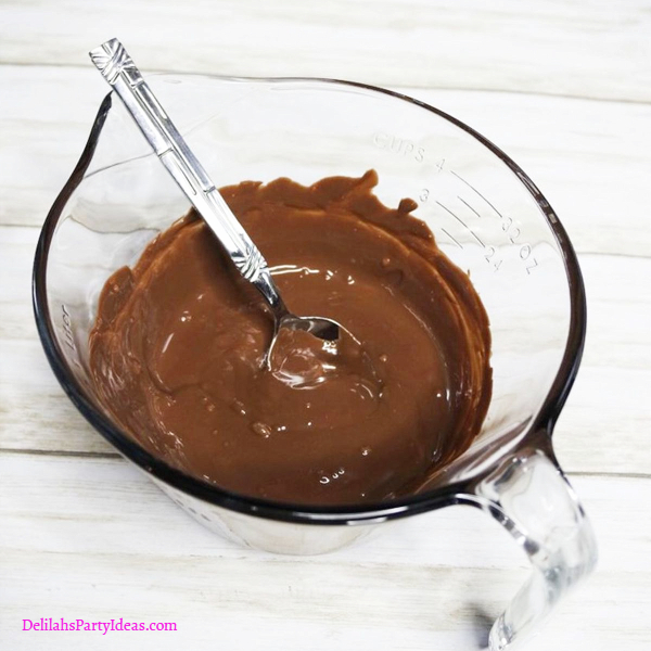 melted chocolate in glass jug with spoon