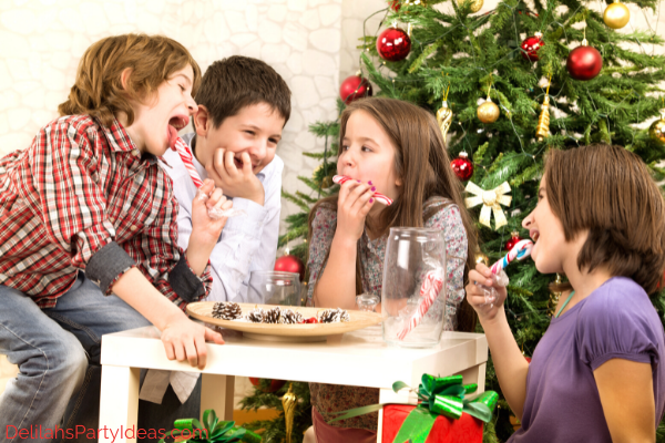 4 Kids sitting around a table eating Candy Canes
