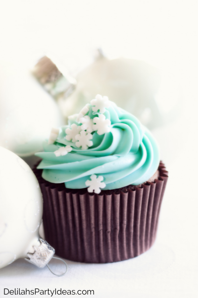 Chocolate Cupcakes with light blue icing and snowflake sprinkles