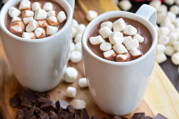 2 white mugs with homemade hot chocolate, with loads of white mini marshmallows on top