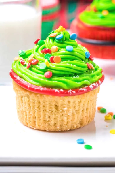 Christmas Tree Cupcake, bright green icing with colorful candies and sprinkles that look like Christmas lights.