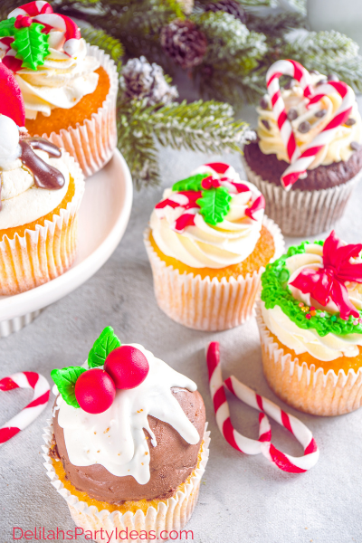 6 Christmas cupcakes with candy canes on table, Christmas pudding, Christmas wreath and candy cane.