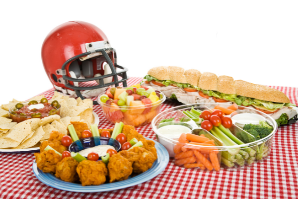 Super Bowl Sunday Food Table set on red and white table cloth with Football helmet
