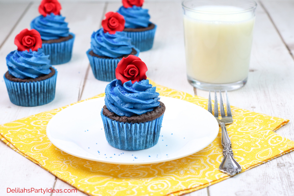 Beauty and The Beast Cupcakes on white plate with yellow napkin