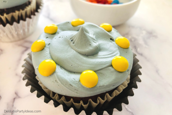 Gray frosting on cupcakes with yellow M&M's