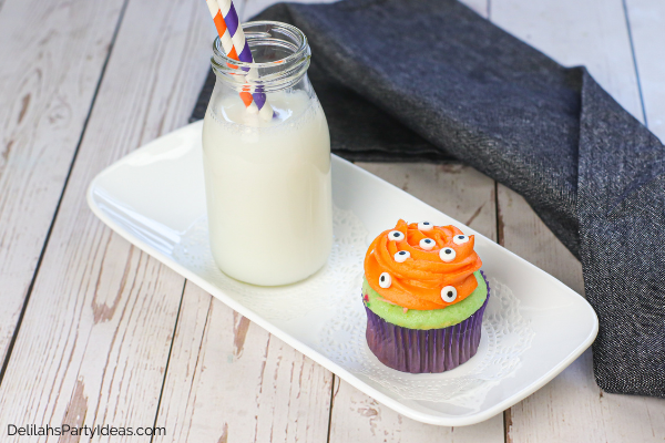 spooky eye cupcakes on a white plate with a glass of milk