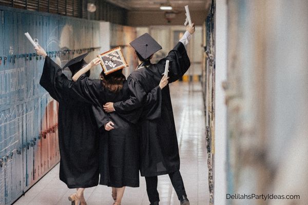 3 High School Students with Graduation caps and robes on