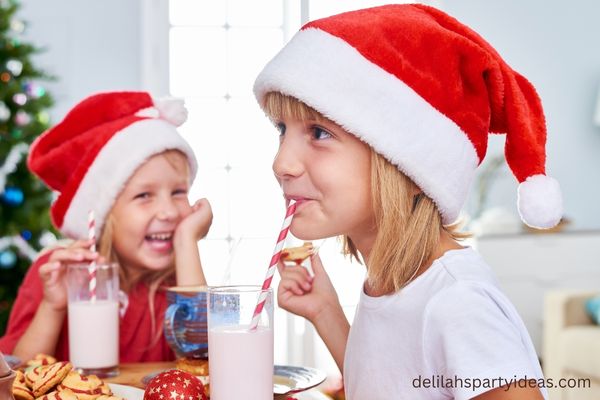 2 Kids drinking milk on Christmas morning with Santa Hats on
