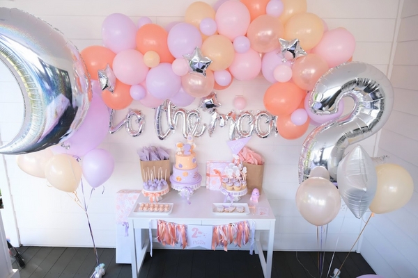 Two the Moon birthday party table with Balloon Garland