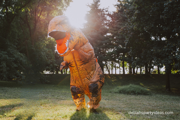 Man dressed in dinosaur costume