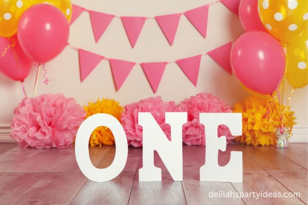 Pink and yellow first birthday party decorations