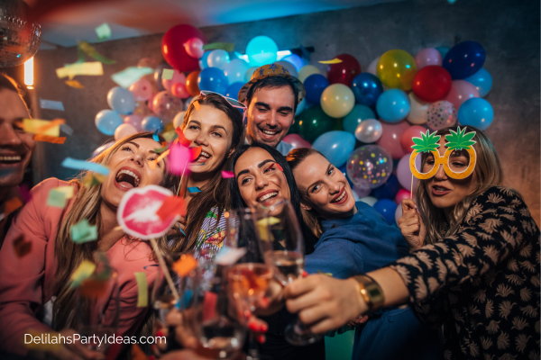 group of adults at a party with photo booth props