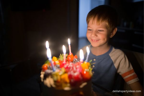 6 year old boy with birthday cake