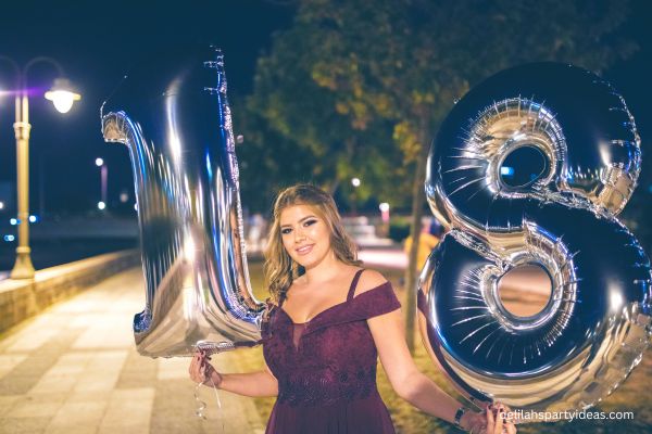 18 year old holding party balloons