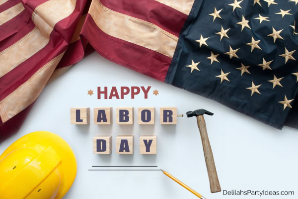 American flag, hard hat, hammer, pencil, with Happy Labor Day text