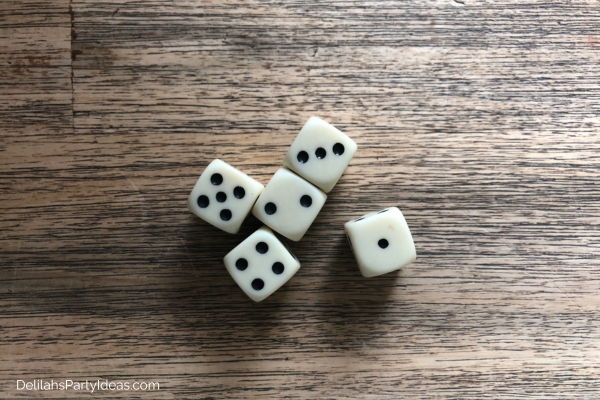 5 white dice on table
