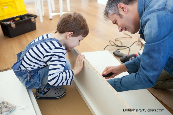 Father and son assembling furniture