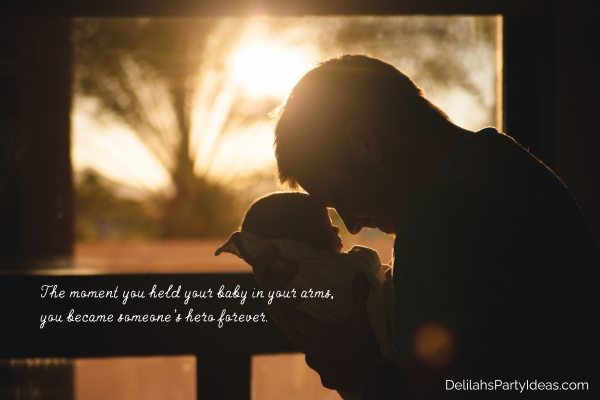 Silhouette of father holding baby  with quote overlay