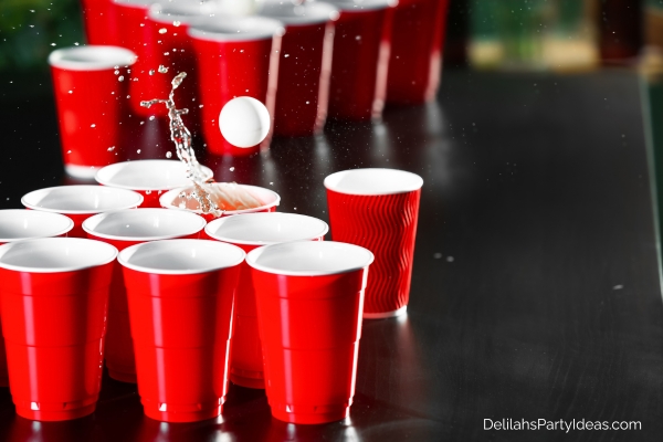 ping pong ball thrown into a cup with water