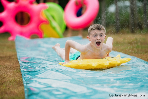 boy sliding belly flop in a slip 'n slide