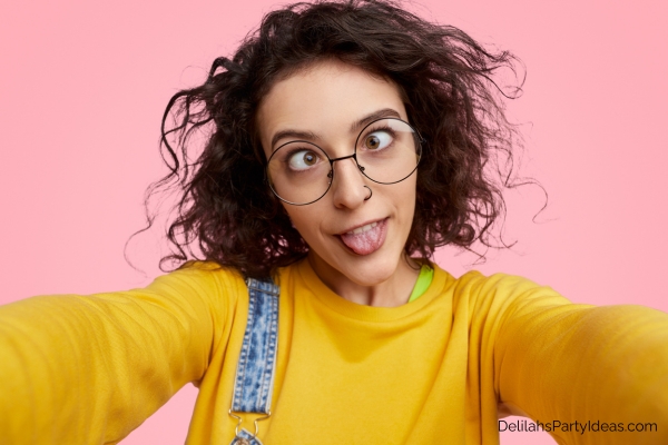 Woman taking silly face selfie