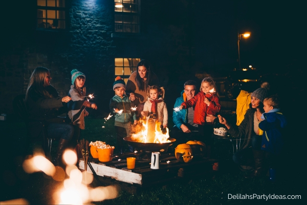 Family and friends gathered round a bonfire