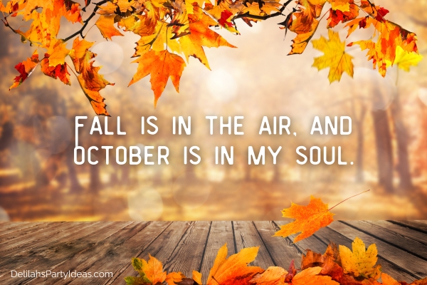 wooden table with orange autumn leaves, with quote overlay