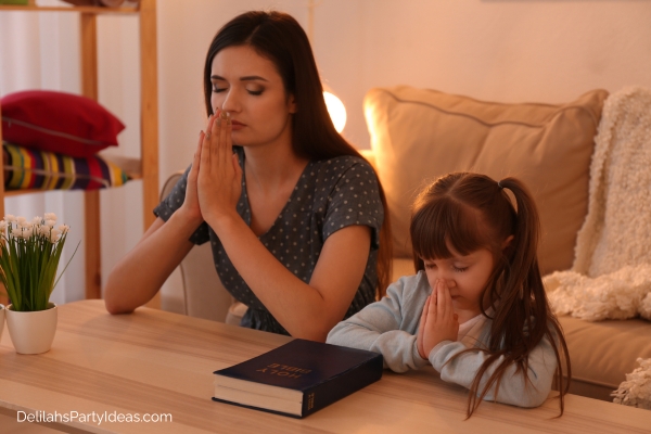 Mom and daughter praying
