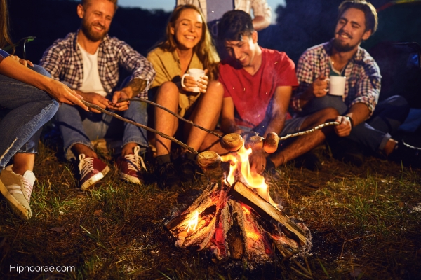 friends toasting marshmallows in campfire