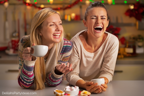 2 women laughing having Christmas snacks