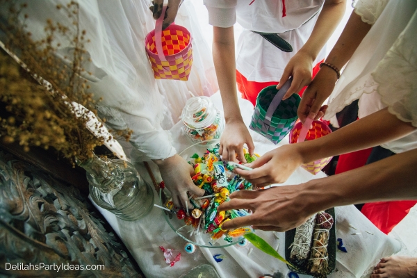 kids getting candies from a bowl for trick or treat