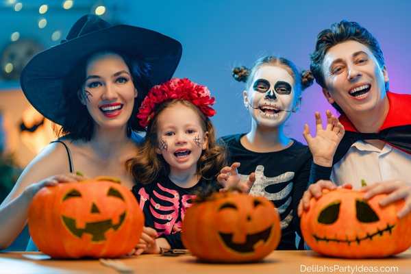 family of 4 all wearing halloween costumes