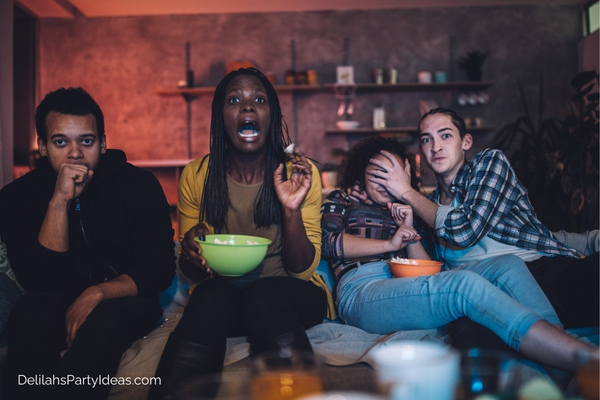 group of friends watching a scary movie