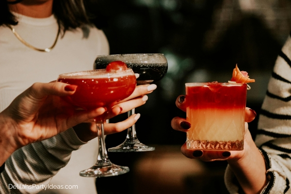 friends each holding cocktail drinks