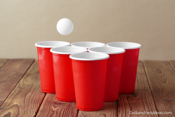 ping pong ball about to fall into one of the plastic cups - ping pong madness game
