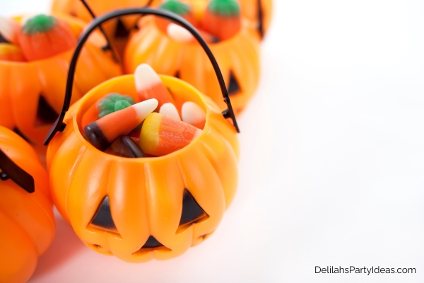 candy corns and other candies inside mini jack o lantern bags