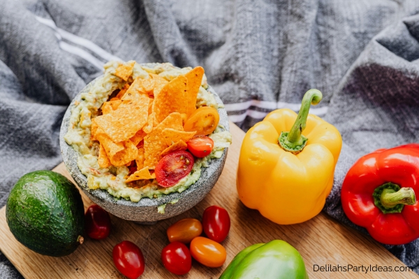 guacamole with nachos, tomatoes, chili peppers
