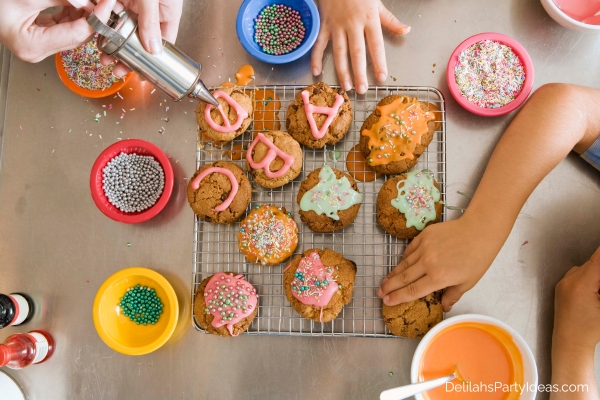 kids decorating cookies with various sprinkles and frosting