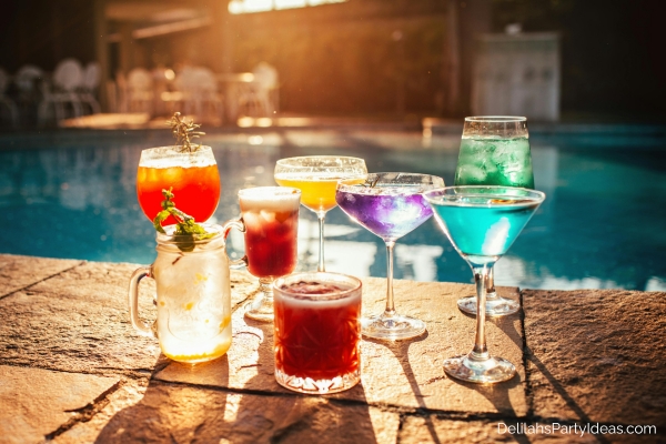 various glasses of mocktails by the pool