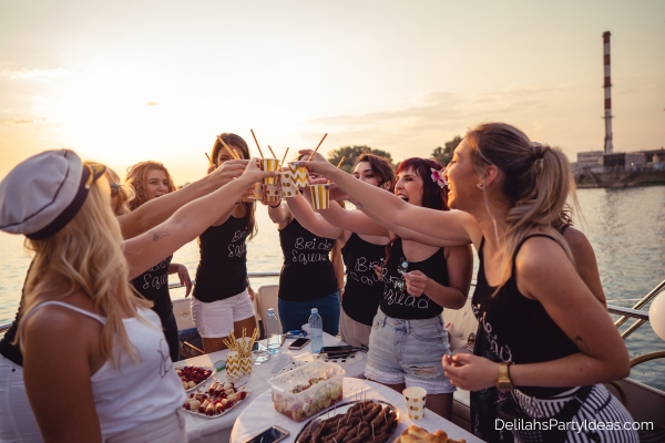women friends celebrating bachelorette party on a boat