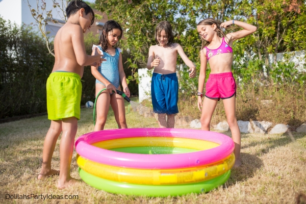 Kids around a kiddie pool in backyard