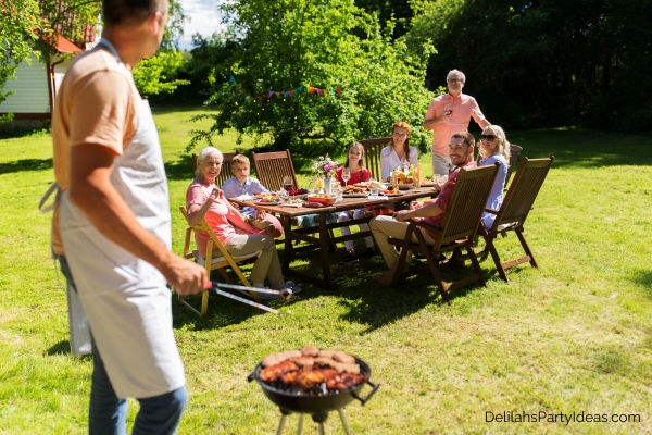 family having a summer barbecue party in their backyard