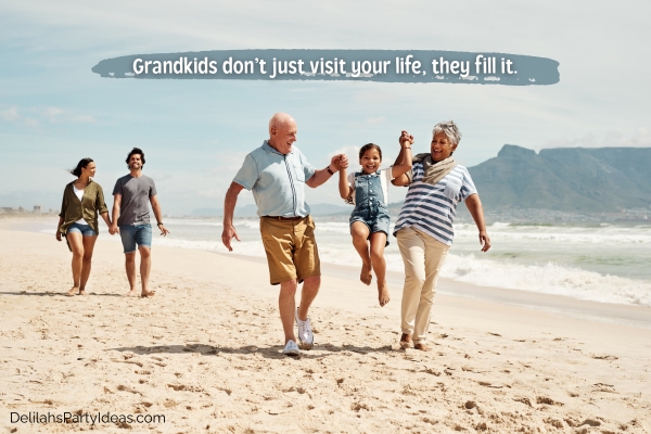 grandparents with granddaughter and her parents walking at the beach with quote overlay