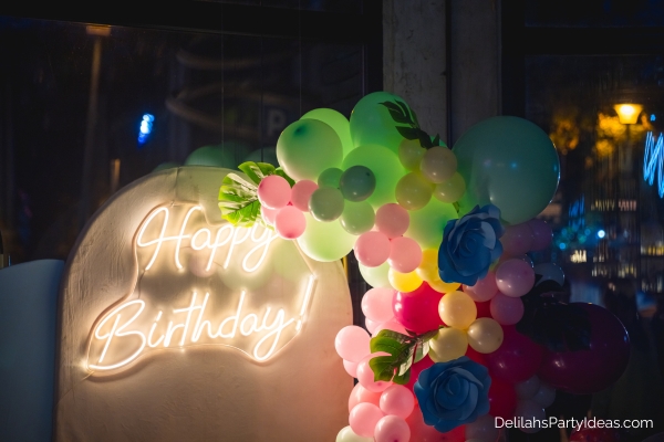 Neon happy birthday sign with balloons