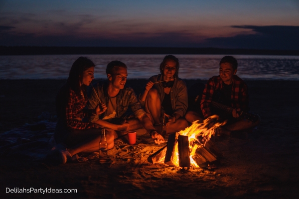 friends around a bonfire at the beach