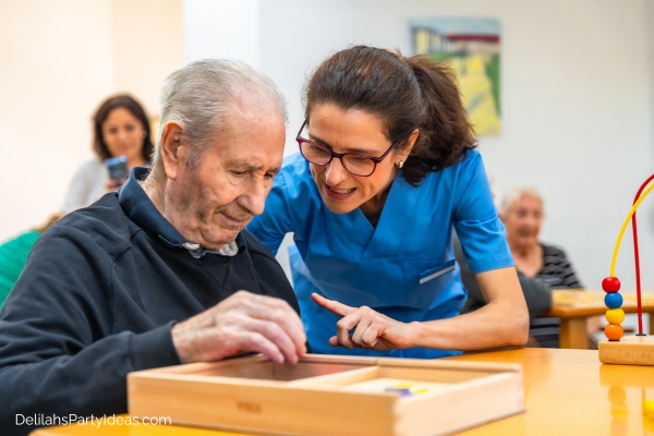 Nurse guiding an elderly man with a memory game