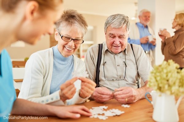 Group of elderly people solving a jigsaw puzzle